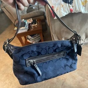Navy blue coach shoulder bag.